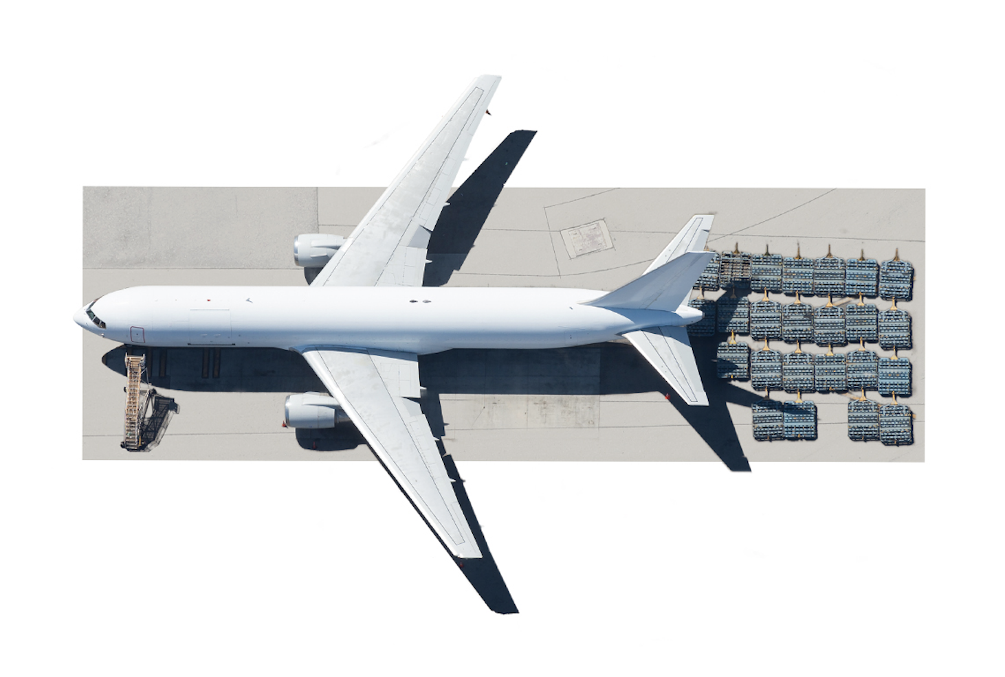 Aerial view of an air freight aeroplane on a runway with its cargo ready for loading at the rear of the plane.